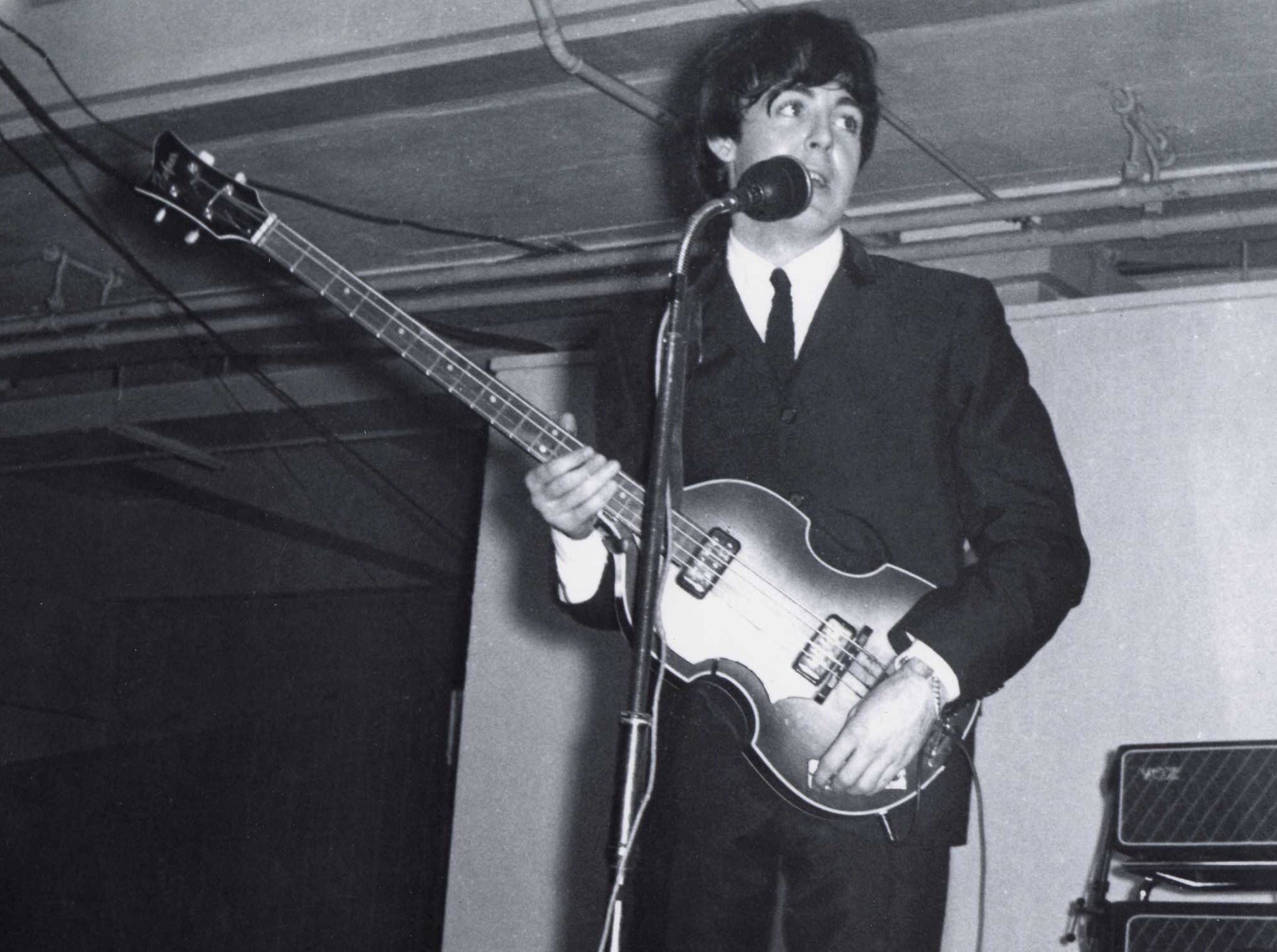 Grayscale Portrait Photo of Paul Mccartney Performing on stage