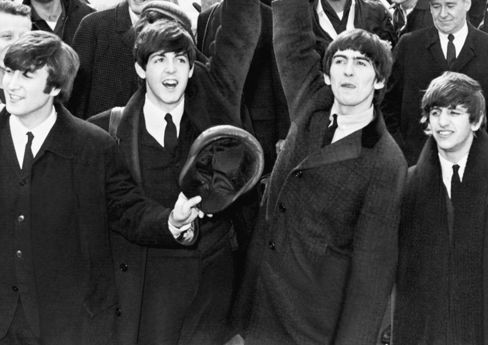 English band The Beatles wave to fans after arriving at Kennedy Airport