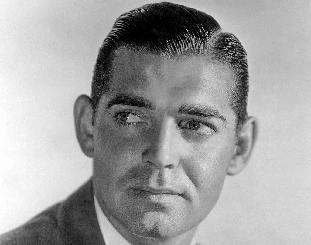 Grayscale Portrait Photo of American film actor Clark Gable looking to the left