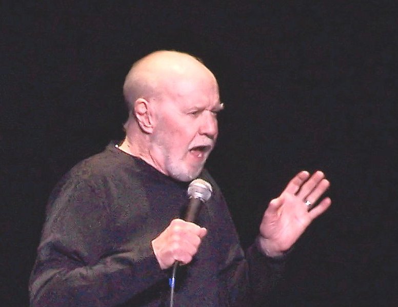 Portrait Photo of George Carlin Performing on stage.