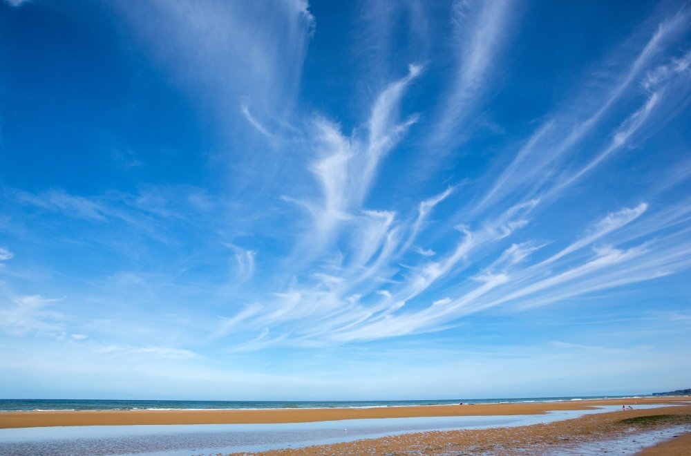 Landscape Photo of Beach during the tide with cirrus clouds above