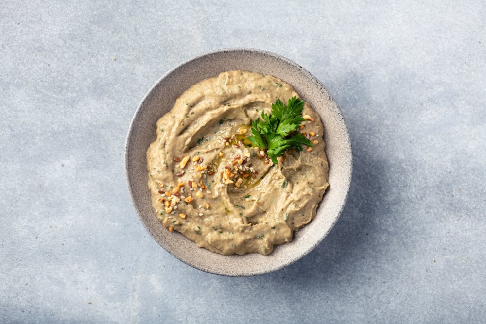 This is a top-down, centered shot of a bowl of Baba Ganoush