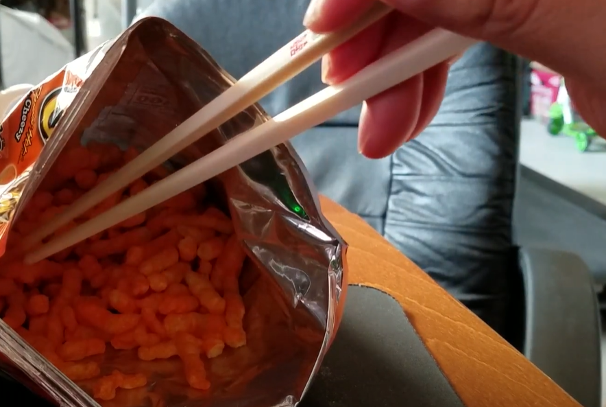 eating cheetos with chopsticks