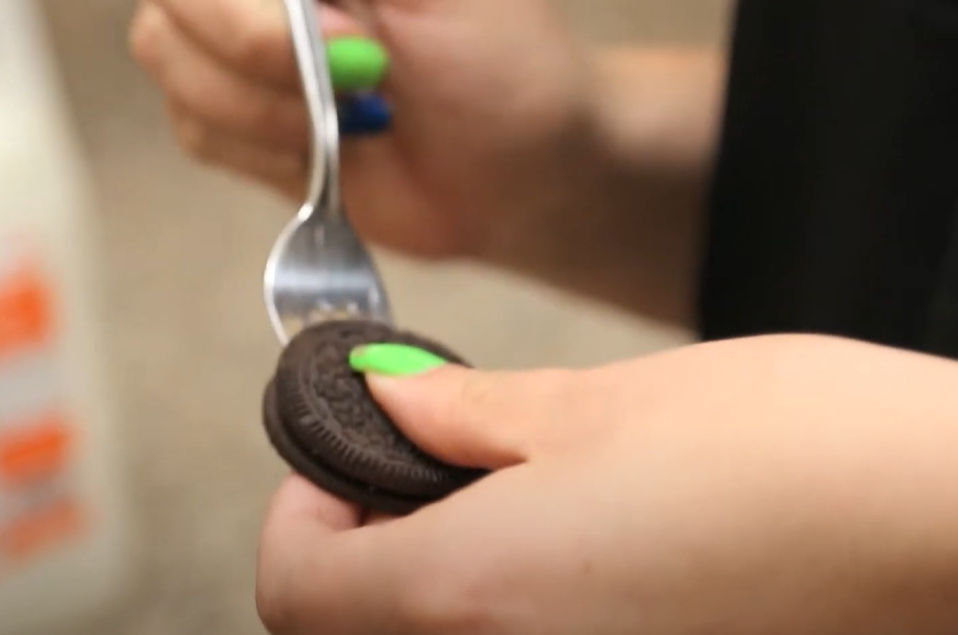 use a fork to dip an Oreo cookie