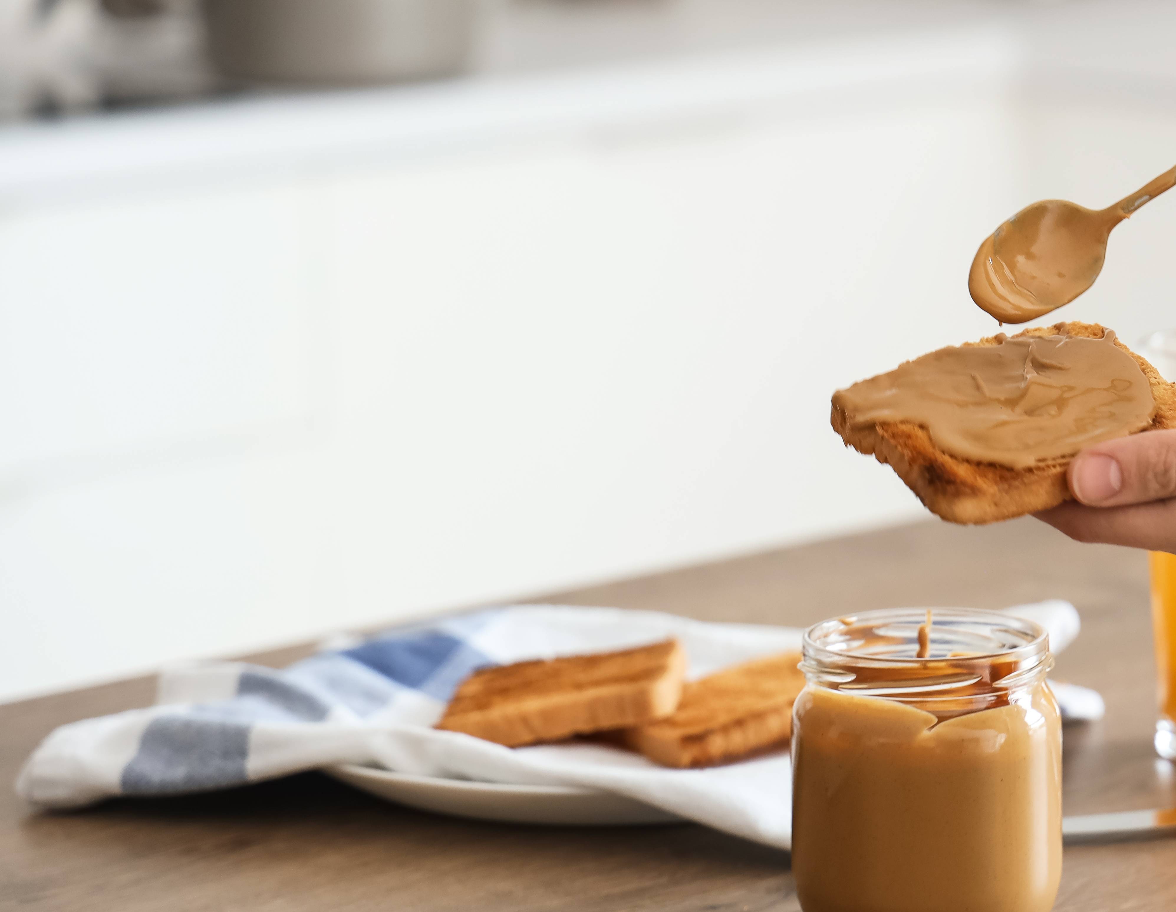 spreading nut butter with spoon
