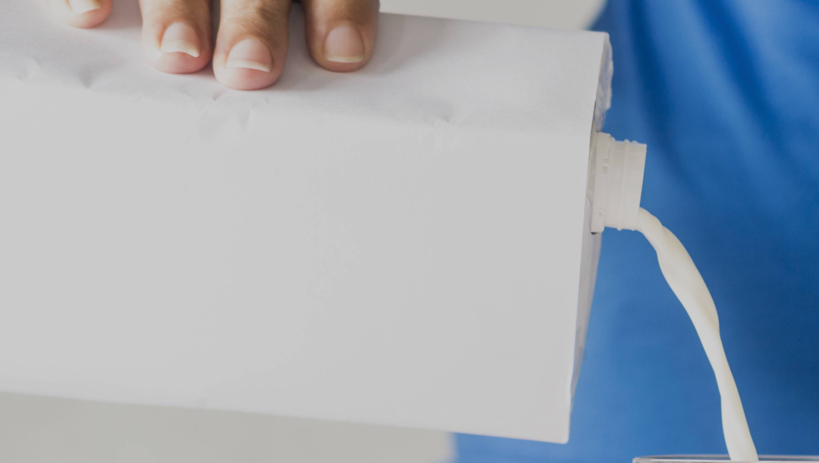 pour milk with the cap towards top