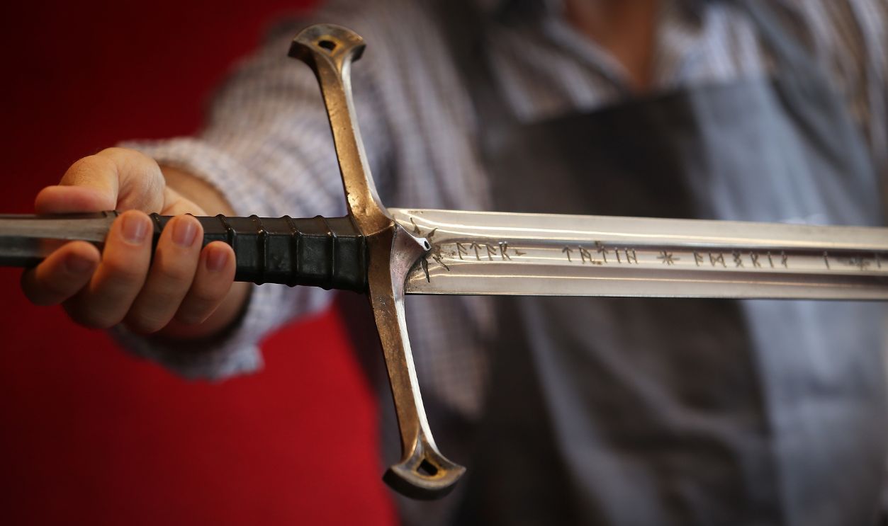 A Bonhams employee holds 'Anduril' a prop sword belonging to Aragorn, hero of 'The Lord of the Rings' movie trilogy on July 31, 2014 in London, England