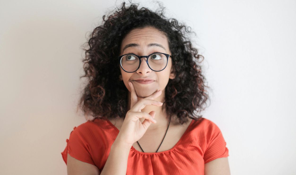 Woman in red top earing glasses