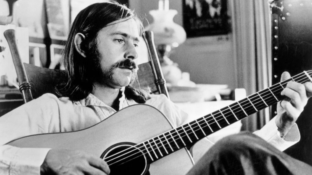 Norman Greenbaum playing on an acoustic guitar