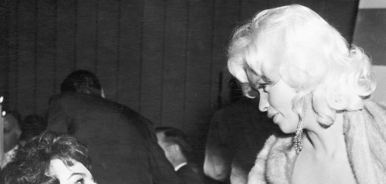 Sophia Loren, Jayne Mansfield, Parsons (Original Caption) 4/12/57-Beverly Hills, California: Italian actress Sophia Loren (left) and glamorous Jayne Mansfield are shown as they met tonight at a gala party in Romanoff's Restaurant. Seated at right is movie columnist Louella Parsons.