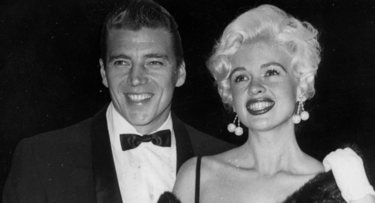Mansfield's Man 12th May 1958: Hollywood sex symbol Jayne Mansfield (1933 - 1967) and her husband Mickey Hargitay smile for the cameras at the Cannes film festival.