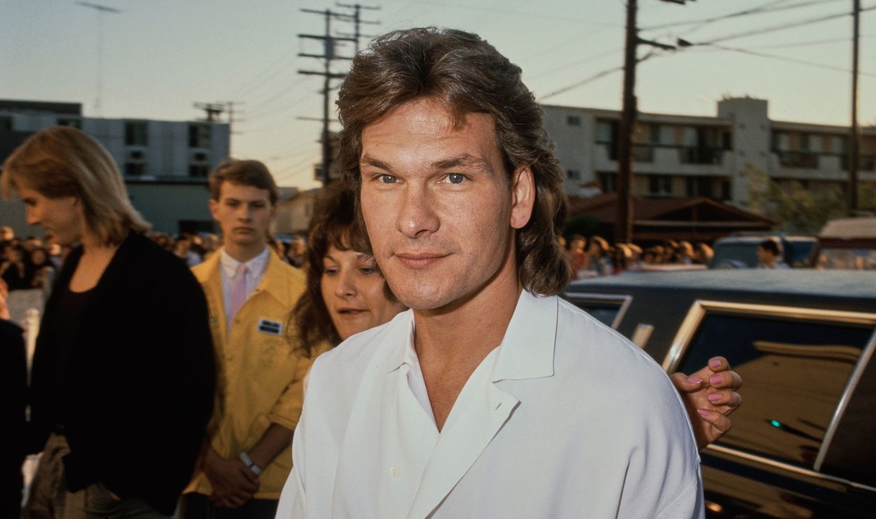 American actor and dancer Patrick Swayze (1952 - 2009) arriving for an in-store promotional event at a record store in Los Angeles, California, to sign copies of the soundtrack to 'Dirty Dancing', 1988.