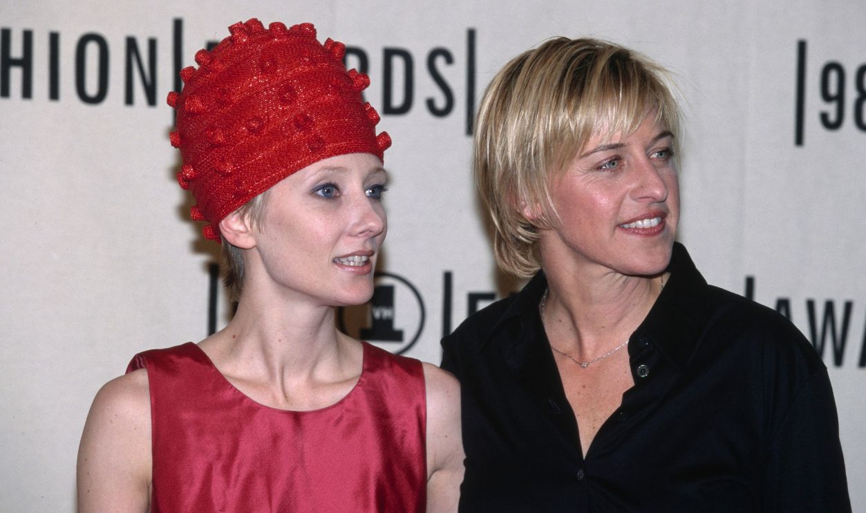 1998 VH1-Fashion Awards American actress Anne Heche, wearing a sleeveless red jewel neck outfit with a red Prada hat, and American television host and comedian Ellen DeGeneres, who wears a black shirt with an open collar, attend the 1998 VH1-Fashion Awards, held at Madison Square Garden, Midtown Manhattan, New York City, New York, 23rd October 1998.