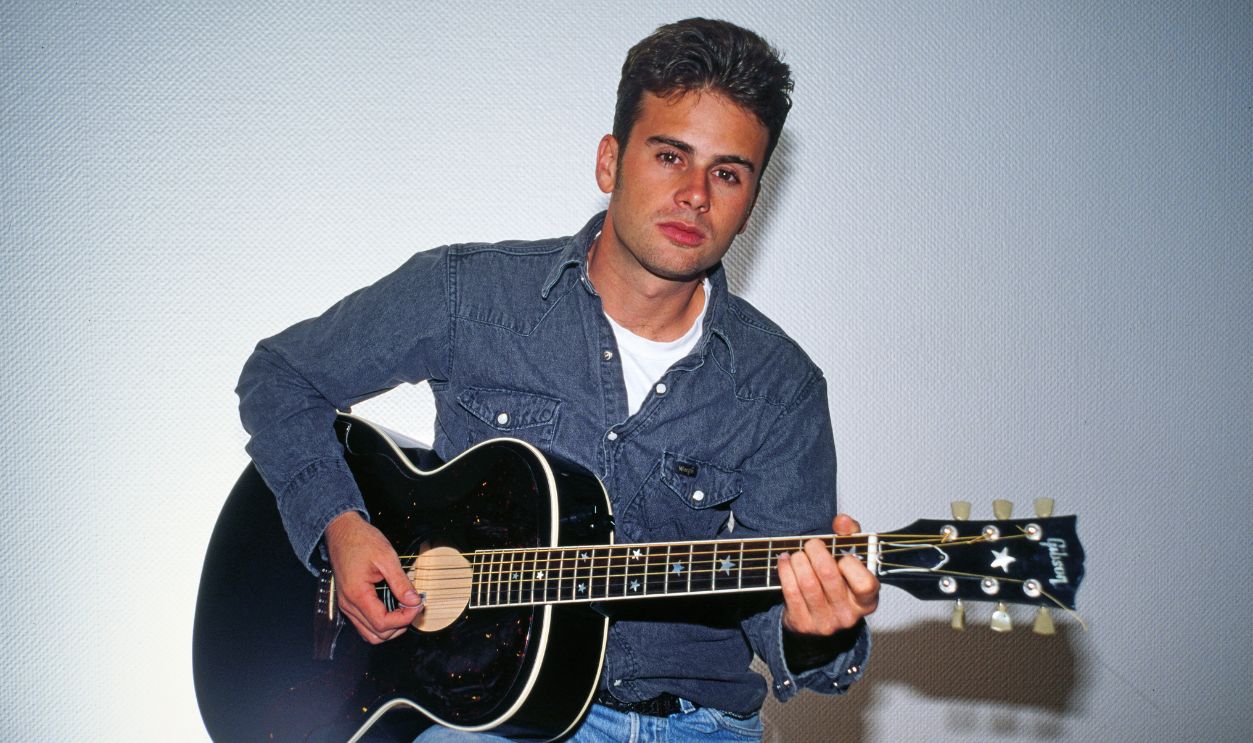 Jamie Walters, aka James Walters, American singer and actor, portrait with guitar, 1994.
