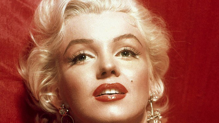 A glamorous Marilyn Monroe in a red dress