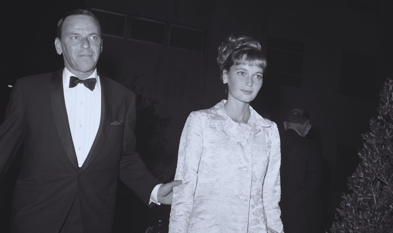 Gettyimages - 515500564, Frank Sinatra Holding Arm of Mia Farrow (Original Caption) Actor singer Frank Sinatra and his date Mia Farrow arrive at the Bistro Restaurant here for a black-tie party given at the request of Princess Margaret.