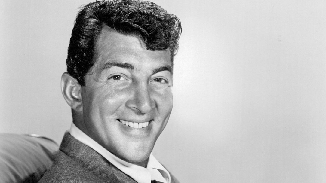Grayscale Portrait Photo of Dean Martin in a gray suit