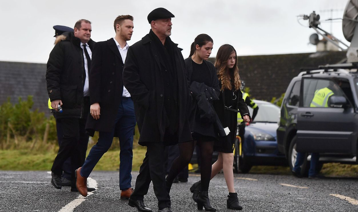 Gettyimages - 909124638, The Funeral Of Cranberries Singer Dolores O'Riordan Takes Place In Limerick LIMERICK, IRELAND - JANUARY 23: Dolores O'Riordan's ex-husband Don Burton and their children Donny (Taylor), Molly and Dakota Burton arrive for Dolores O'Riordan's funeral at St Ailbe's parish church in Ballybricken on January 23, 2018 in Limerick, Ireland. The Cranberries singer, aged 46 was found unresponsive in a London hotel last week. Police are not treating her death as suspicious. An inquest into O'Riordan's death was opened and adjourned until April while the coroner awaits test results. The Cranberries' debut album 'Everybody Else Is Doing It, So Why Can't We?' sold 40 million records in the early 1990's.