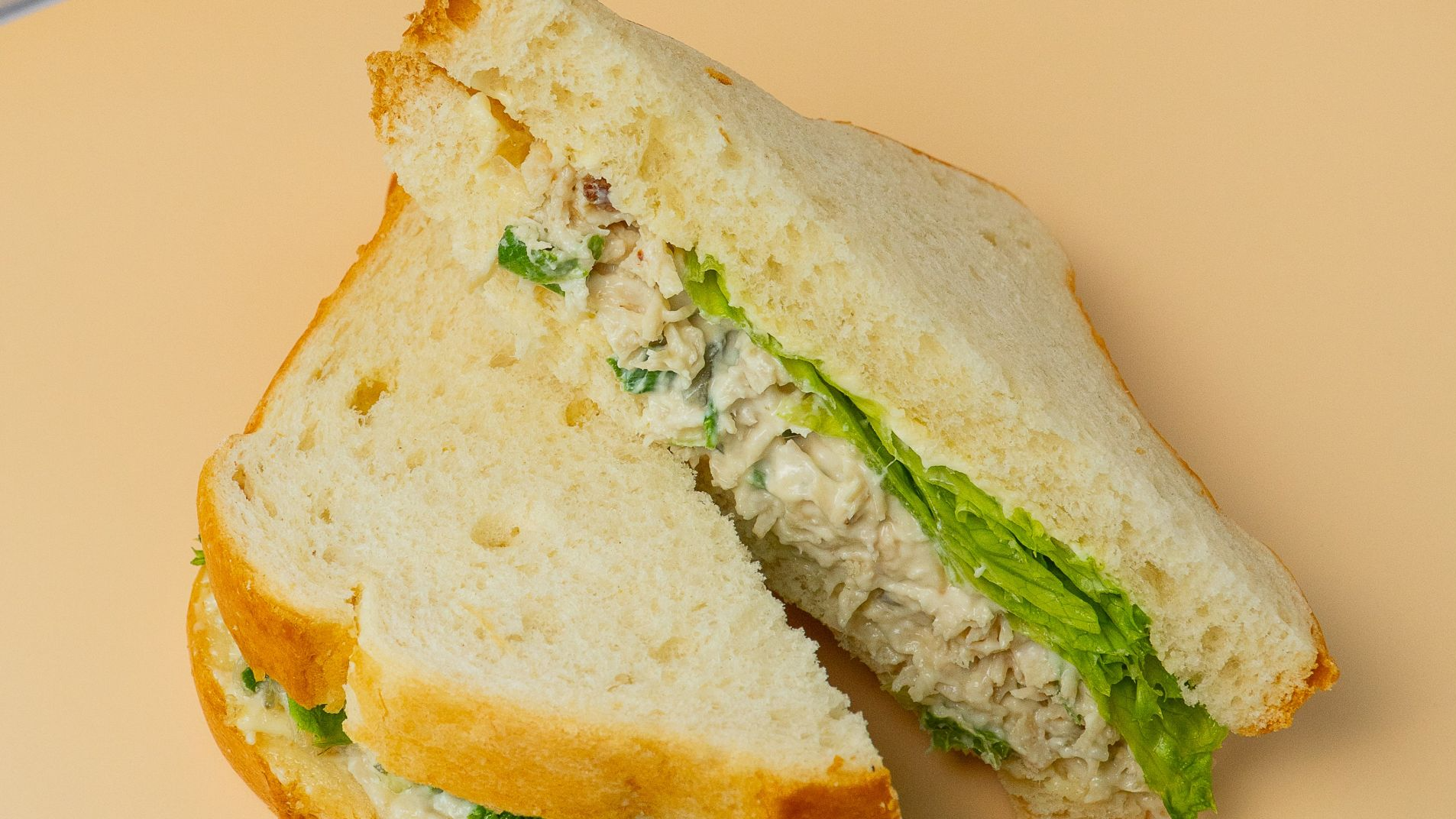 Chicken salad sandwich with lettuce on white bread