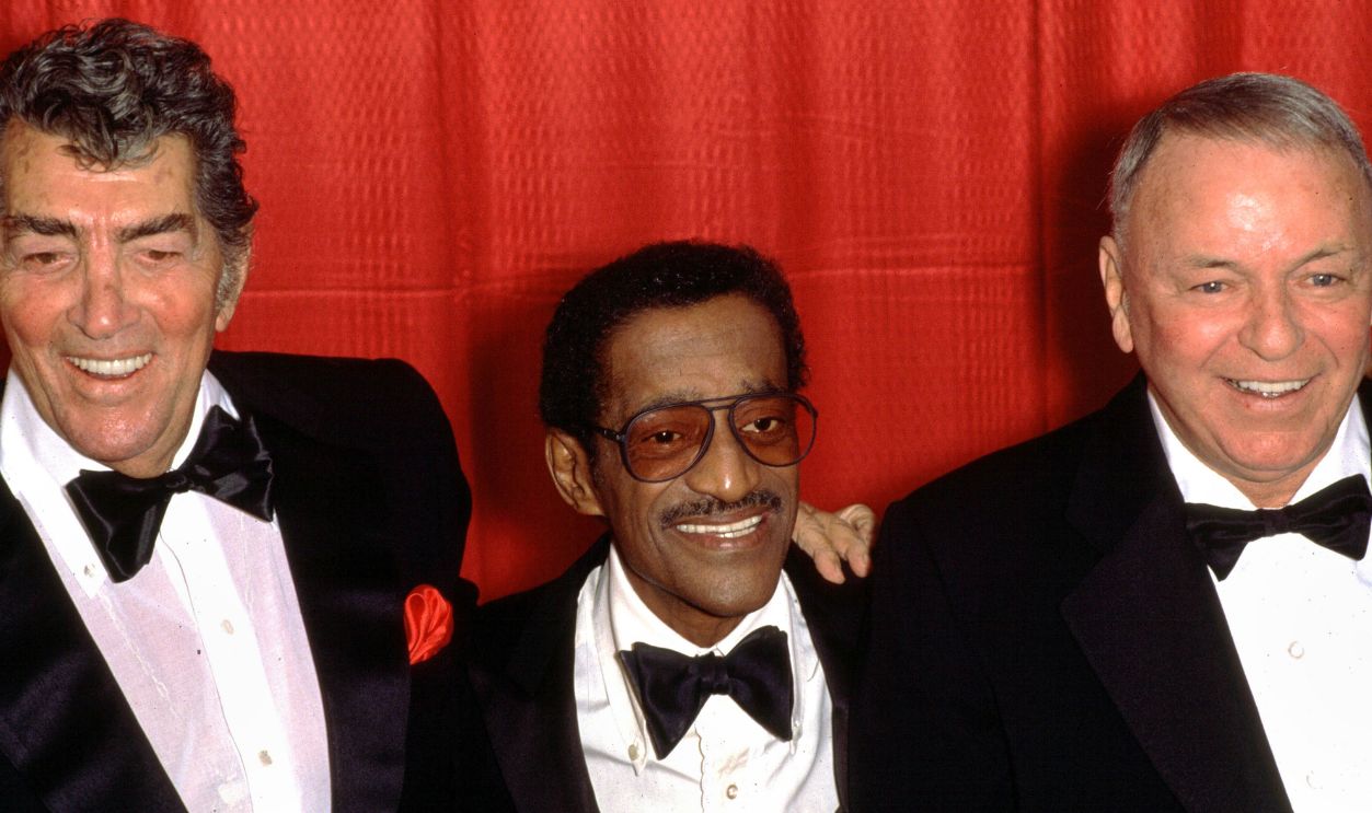 Legendary 'Rat Pack' entertainers Dean Martin, Sammy Davis Jr. and Frank Sinatra pose for photos at a press conference announcing their 1988 'Together Again' concert tour, at Chasen's restaurant in West Hollywood, California on December 8, 1987.
