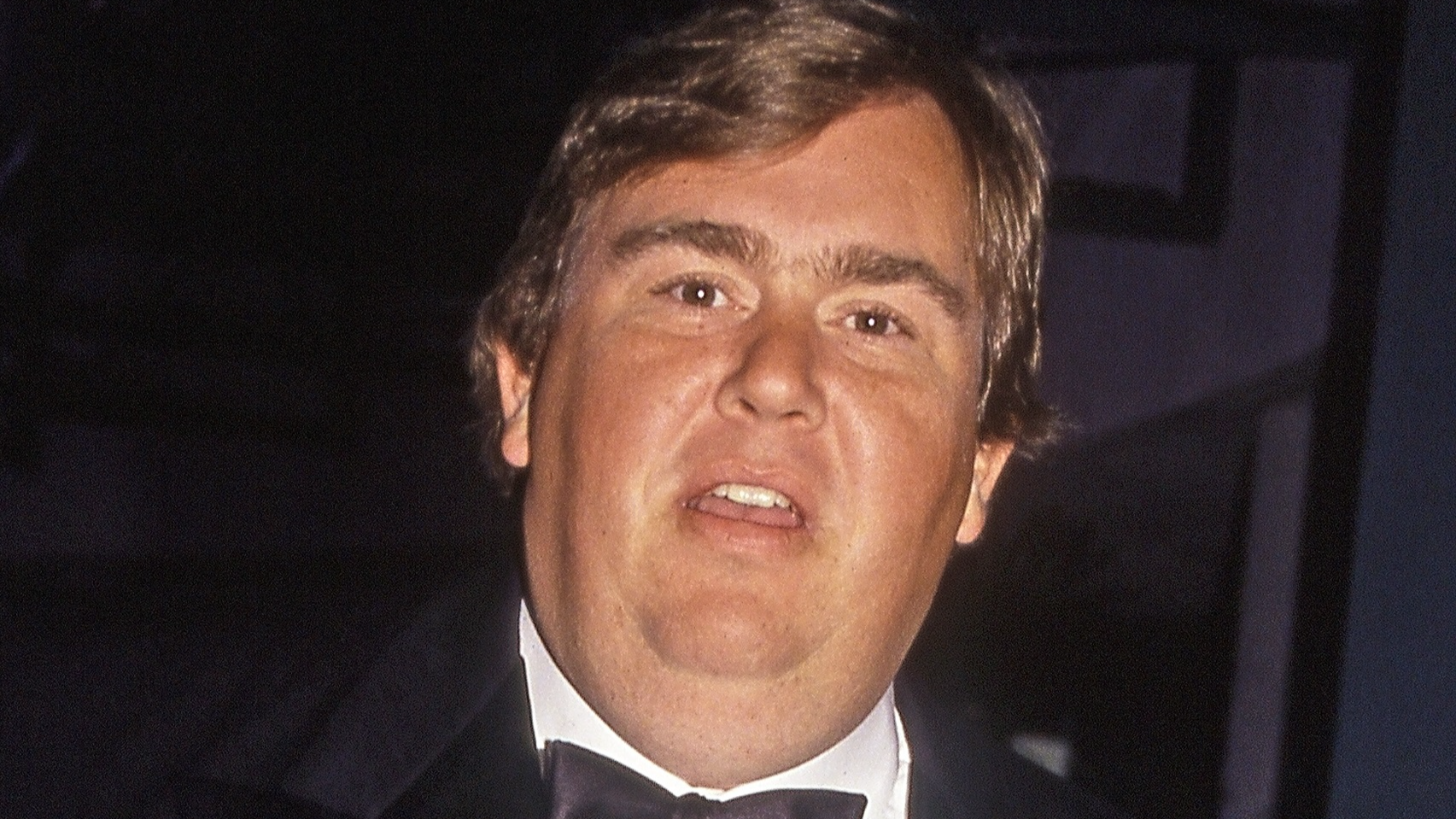 John Candy wearing black suit with bow tie - 1991