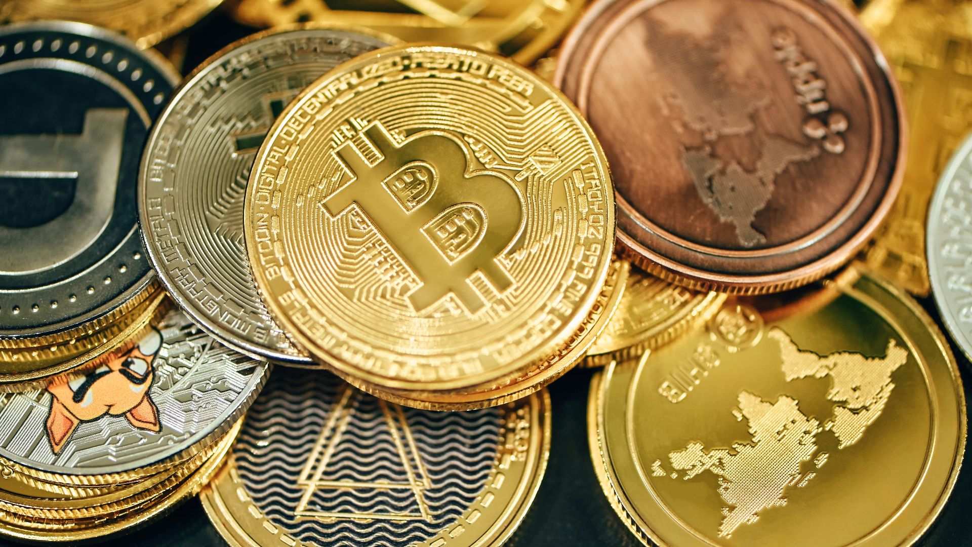 a pile of gold and silver bitcoins