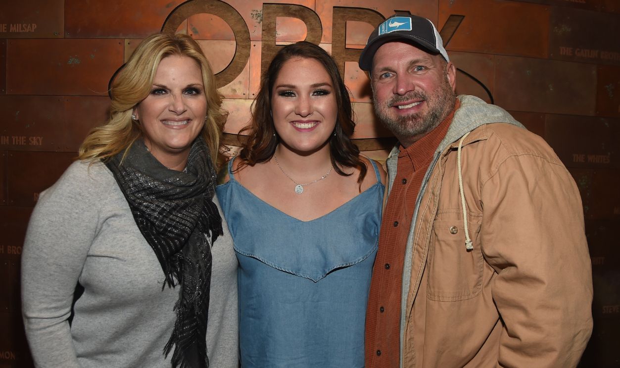 Singer/Songwriter Allie Colleen Brooks (center) Daughter of Garth Brooks and first wife Sandy Brooks poses with her stepmom Singer/Songwriter Trisha Yearwood and dad Singer/Songwriter Garth Brooks after making her Grand Ole Opry debut during Dr. Ralph Stanley Forever: A Special Tribute Concert at Grand Ole Opry House on October 19, 2017 in Nashville, Tennessee.