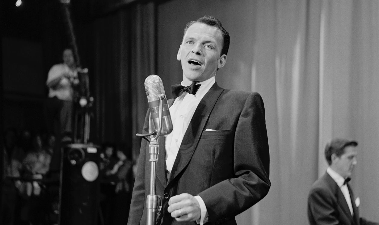 United Cerebral Palsy Telethon, KECA-TV Studios, Los Angeles, California American singer and actor Frank Sinatra, wearing a tuxedo and bow tie, performs during the United Cerebral Palsy telethon, at the studios of KECA-TV in Los Angeles, California, 16th June 1952. 
