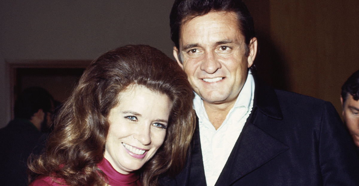 Country singers Johnny Cash and June Carter smiling together.