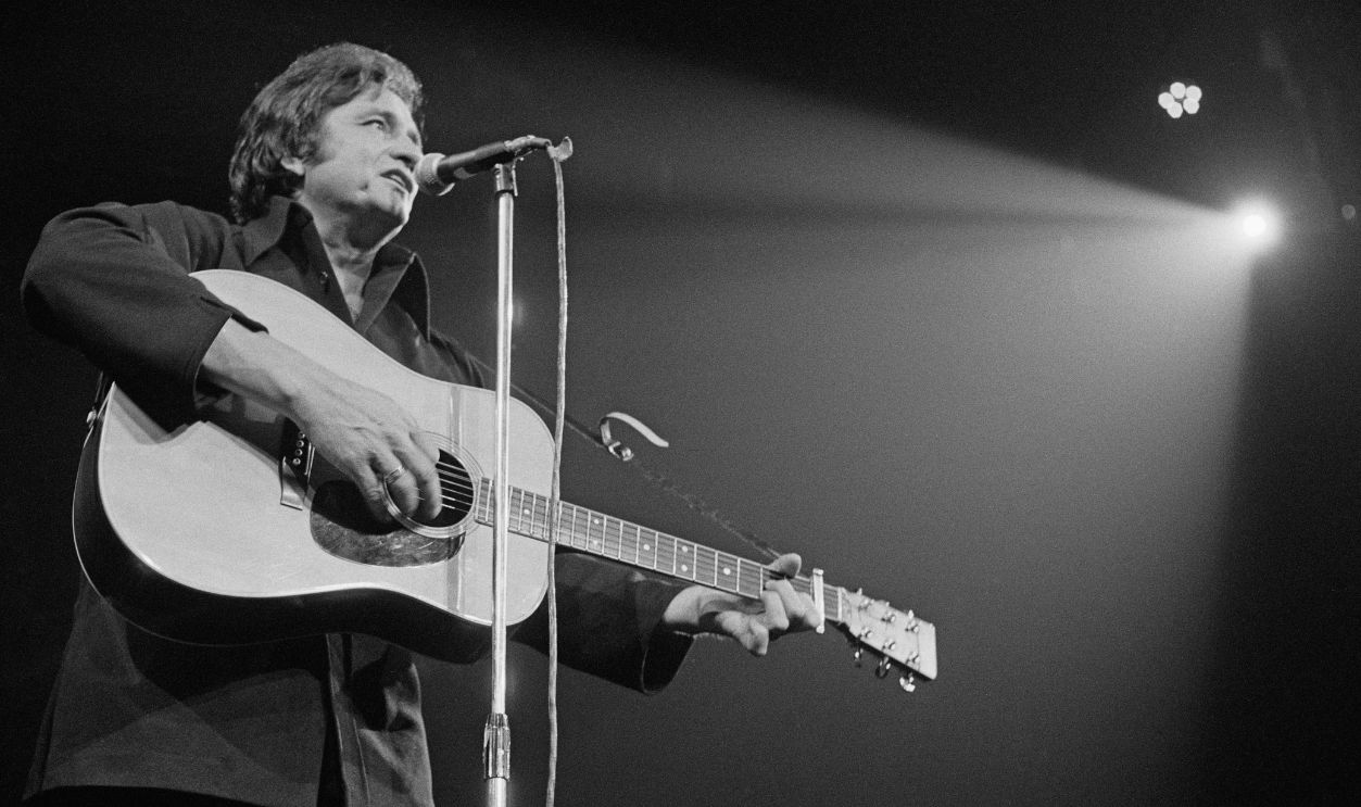 American country and western singer-songwriter Johnny Cash (1932 - 2003) performing at the Royal Albert Hall, London, 27th September 1972.