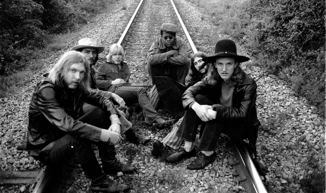 Rock group The Allman Brothers (L-R) Duane Allman, Dickey Betts, Gregg Allman, Jai Johanny Johanson, Berry Oakley and Butch Trucks sit on some rairoad tracks on May 5, 1969 outside of Macon, Georgia.