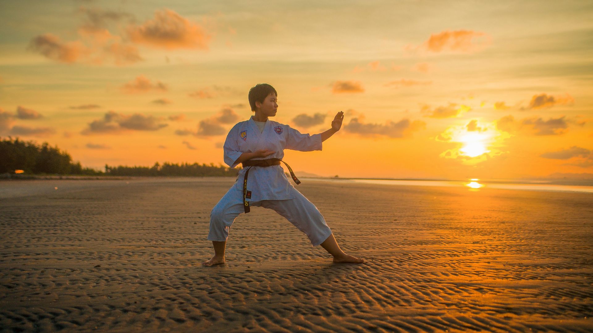 boy doing karate routines during golden hour