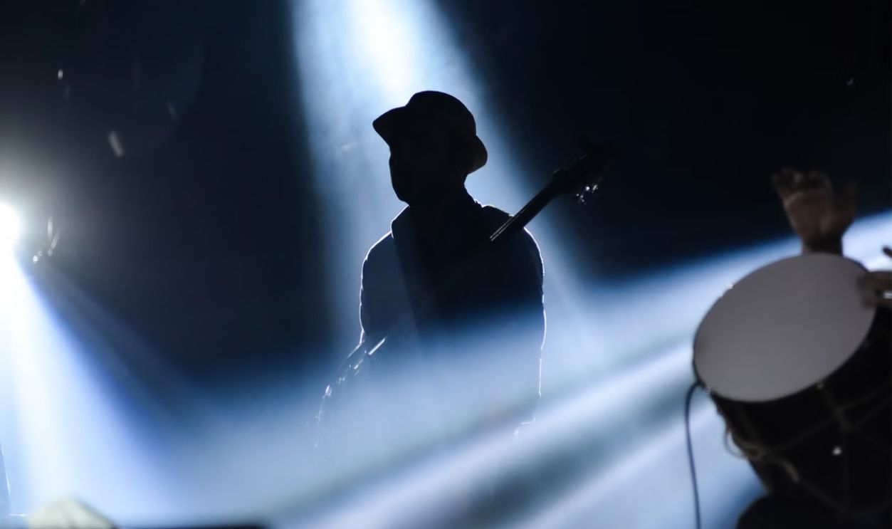 Silhouette of a musician playing on stage with dramatic lighting in Istanbul