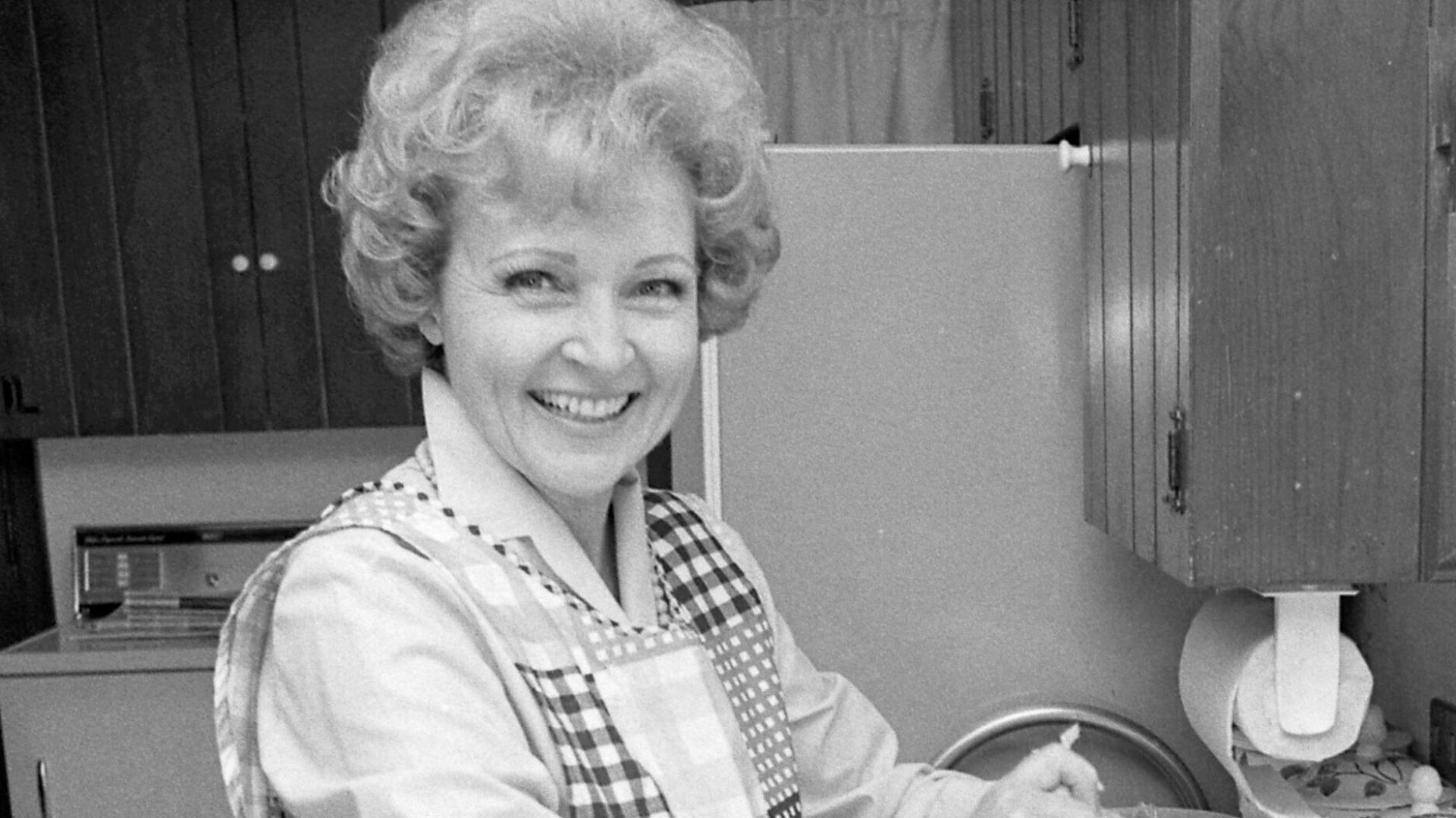 Actress Betty White preparing a meal in Los Angeles.
Original caption: ONE HAPPY HOMEMAKER?—Betty White, who plays a home economist on Mary Tyler Moore Show, projects an unrealistic image of their profession, say home economists.