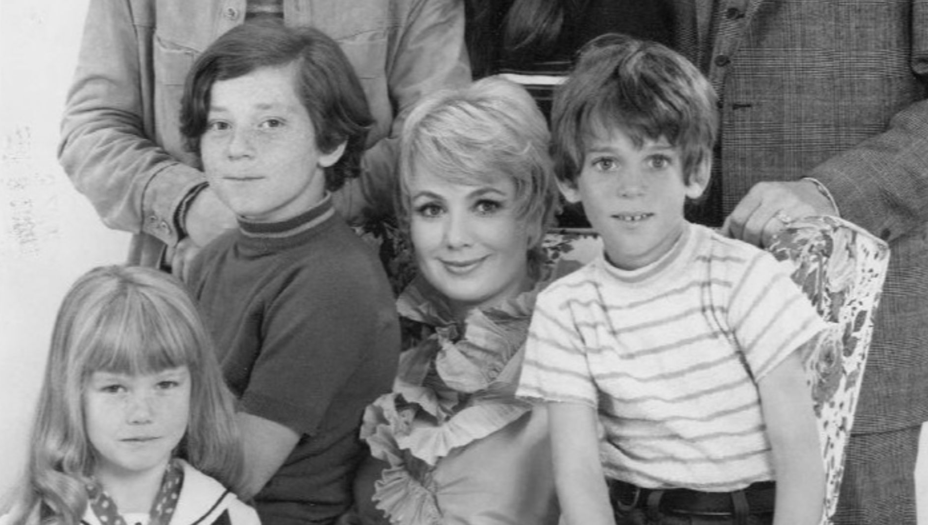 Publicity photo of television actors, (standing; L–R) David Cassidy, Susan Dey, Dave Madden, (sitting; L–R) Danny Bonaduce, Shirley Jones, Jeremy Gelbwaks, and (front; left) Suzanne Crough  promoting the ABC comedy series The Partridge Family, circa 1970.