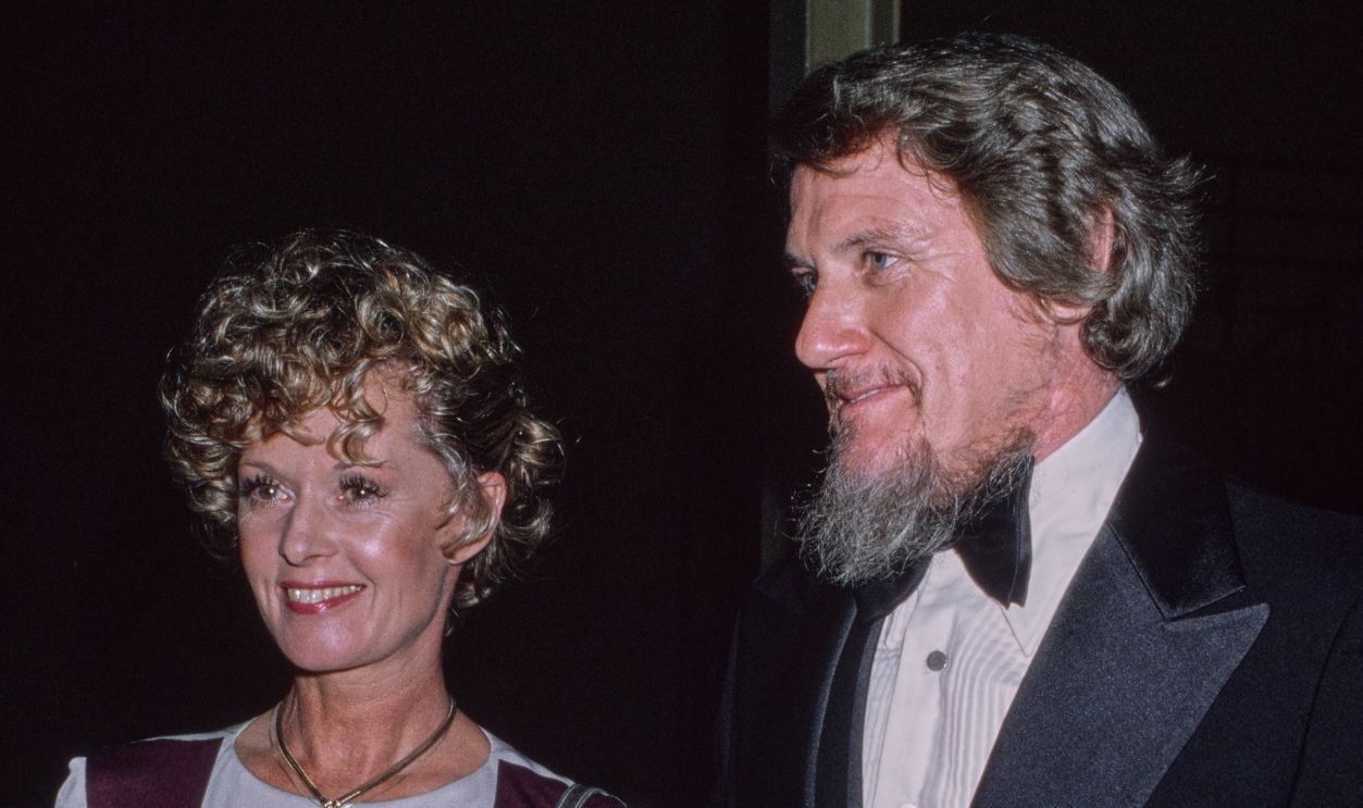 American actress Tippi Hedren, wearing a lilac-and-purple outfit, and her husband, American talent agent and actor Noel Marshall, who wears a tuxedo and bow tie, attend an event, United States, circa 1981