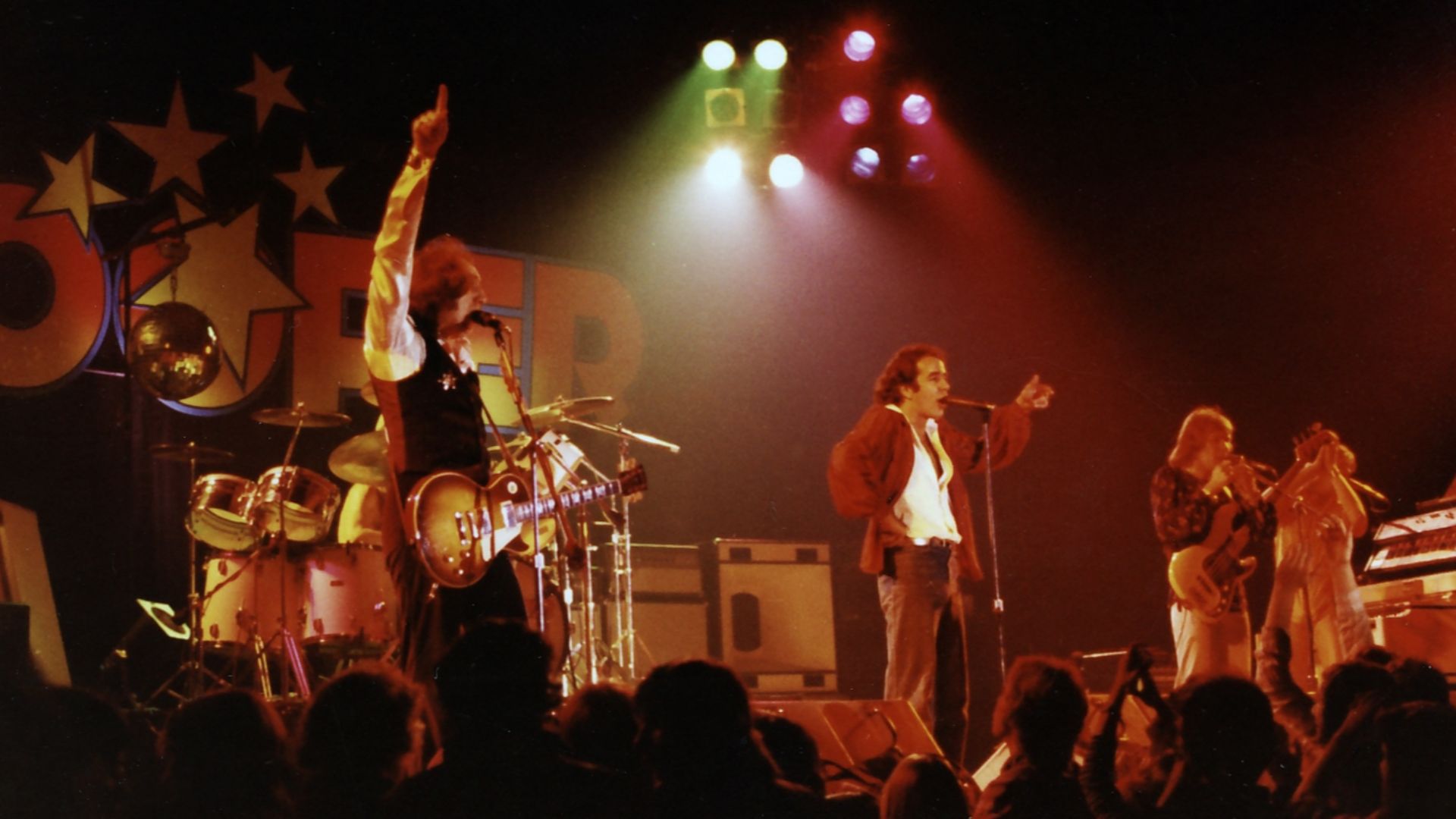 Trooper performing live in 1975. L-R: Tommy Stewart (view blocked), Brian Smith, Ra McGuire, Doni Underhill, Frank Ludwig