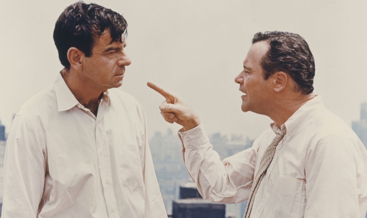 Jack Lemmon points finger at Walter Matthau on rooftop in a scene from the 1968 Neil Simon comedy 'The Odd Couple'.