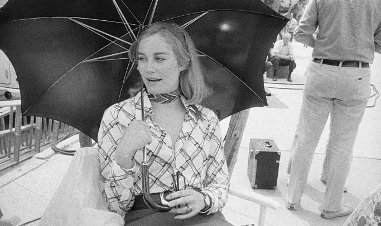 (Original Caption) Lady in Waiting. Brooklyn Heights, New York, New York: Shaded by an umbrella, actress Cybill Shepherd is a study in serenity during a hot, humid day at work in New York's Brooklyn Heights section recently. She's standing by on the set during location filming for Taxi Driver. new Columbia Pictures movie in which she stars with Robert DeNiro.