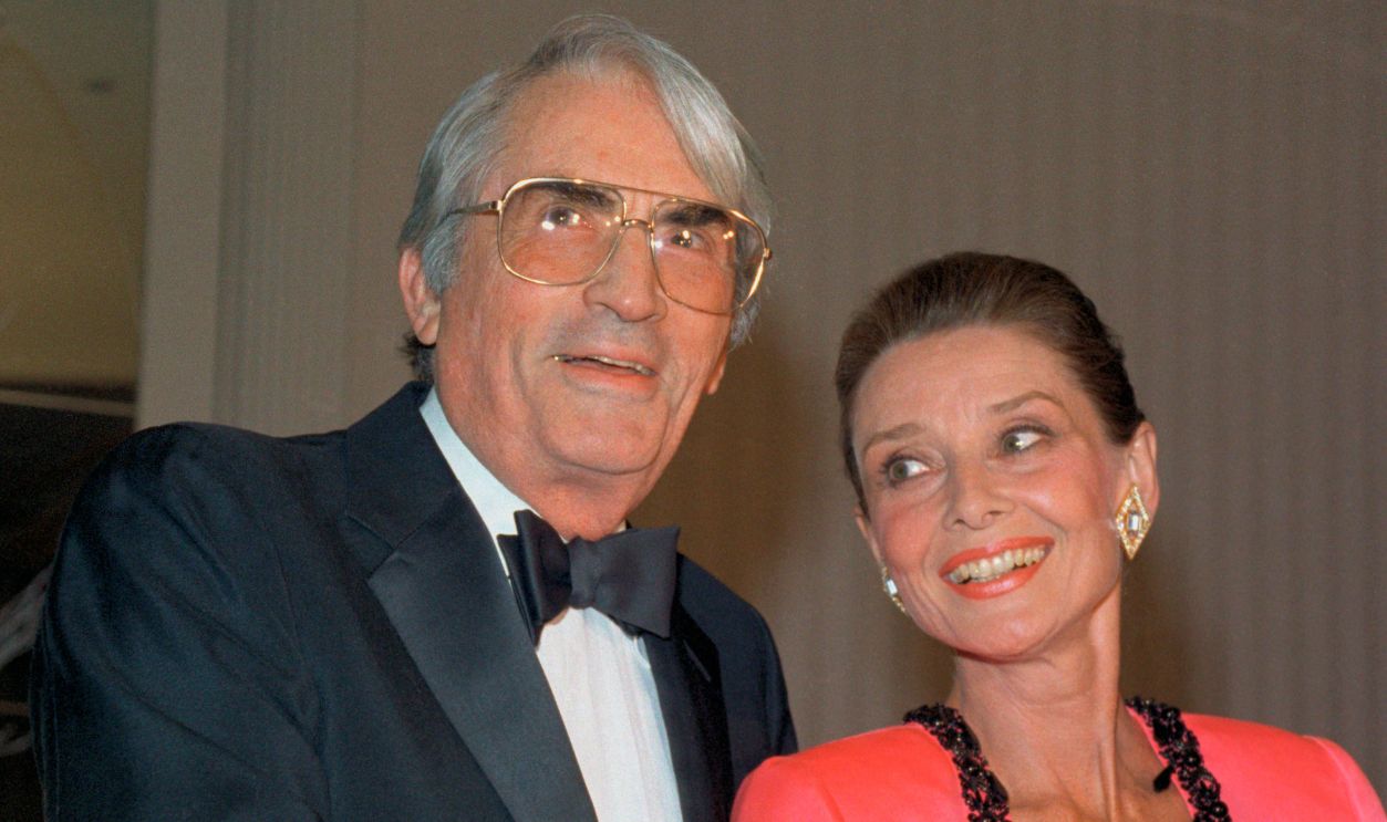 New York: Gregory Peck shares a happy moment with Audrey Hepburn after he presented her with the first annual Winternight Award on behalf of the Lighthouse (The New York Association for the Blind) here November 30th. Peck was Miss Hepburn's co-star in her Academy Award winning United States debut film, Roman Holiday. The Actress received her award for her work with children worldwide as Special Ambassador for UNICEF.