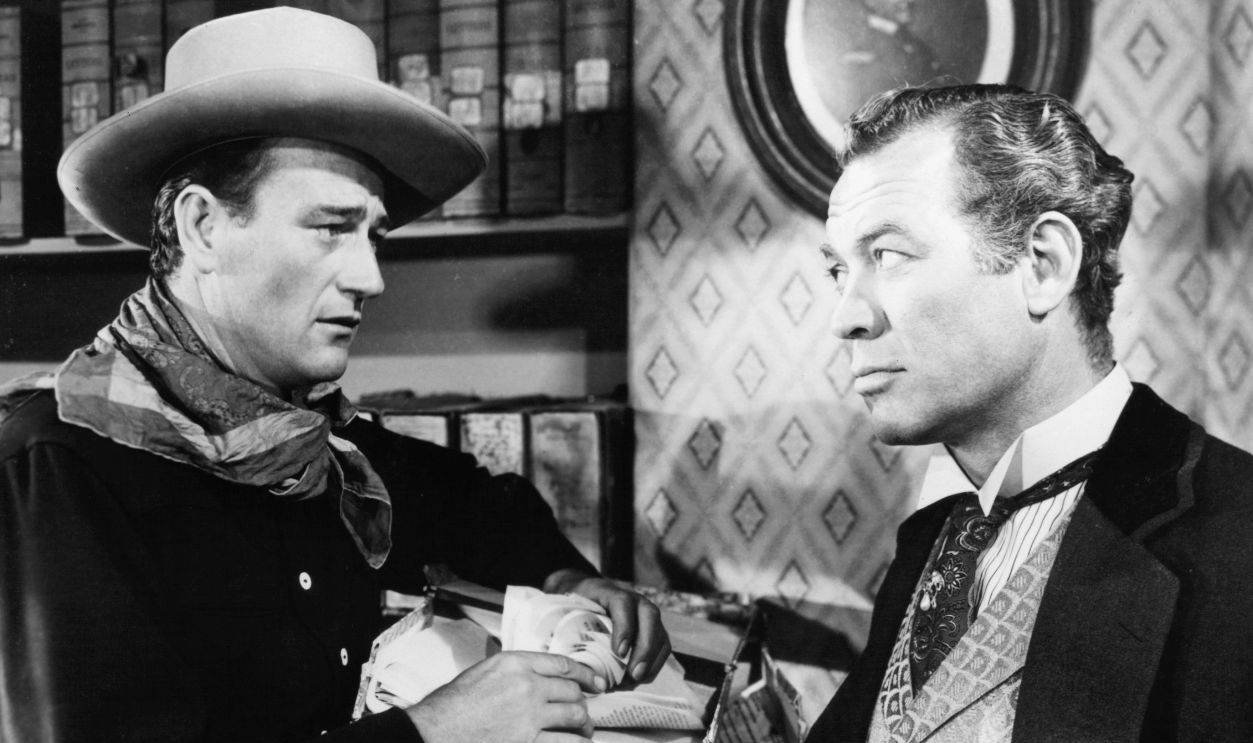 John Wayne and Ward Bond stare at each other in a scene from the film 'Tall In The Saddle', 1944.