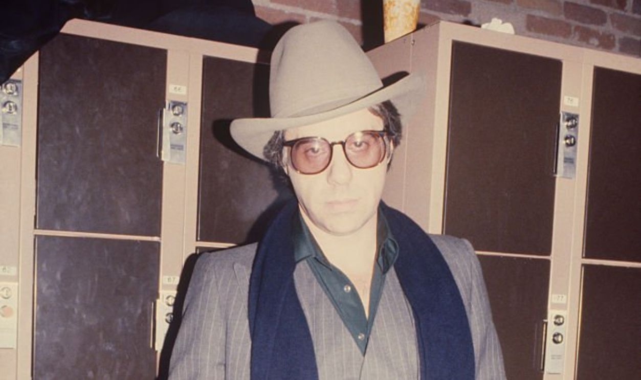 Peter Bogdanovich in a pinstriped suit with blue scarf; circa 1970; New York.