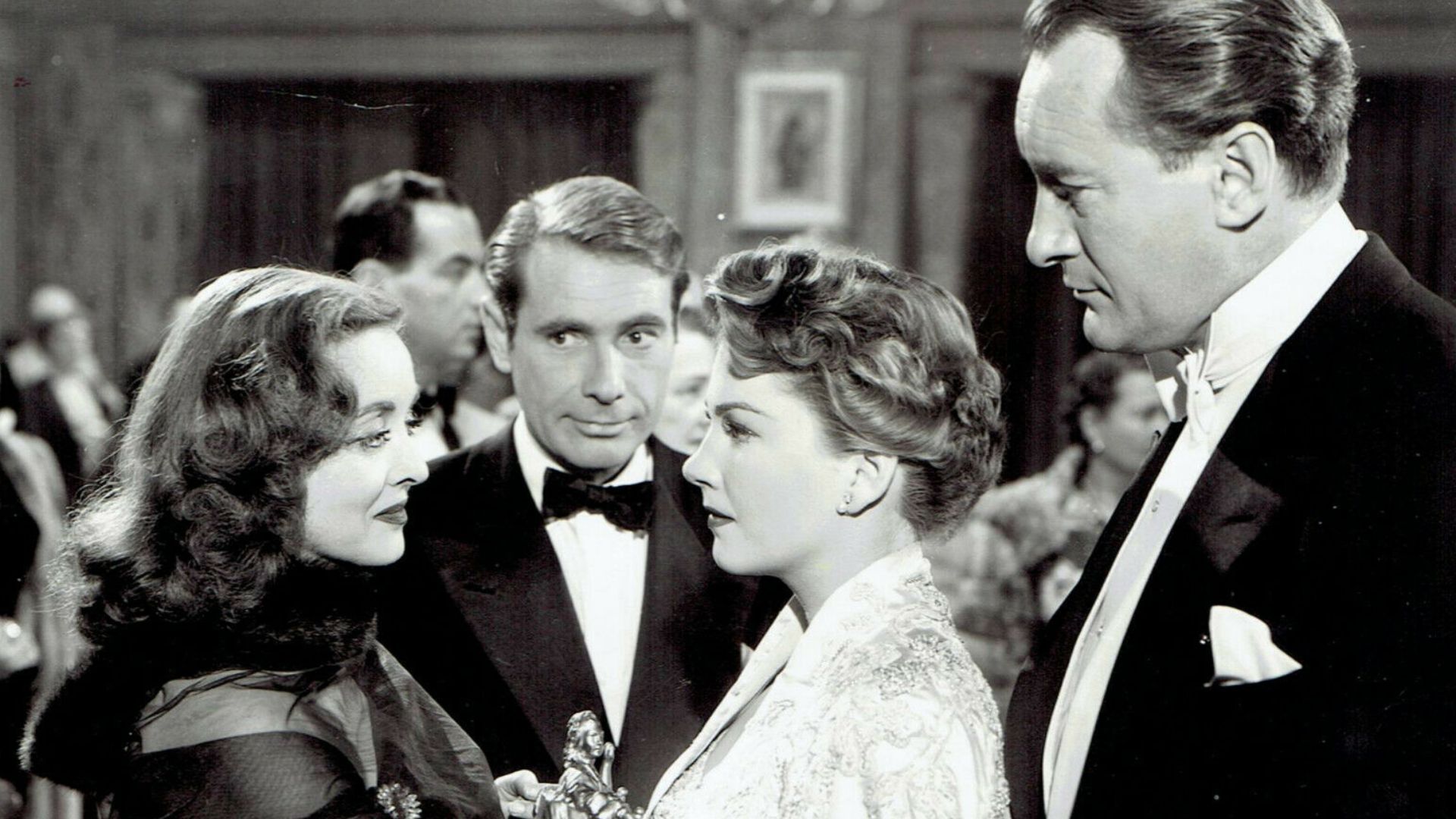 Bette Davis, Gary Merrill, Anne Baxter and George Sanders pose for a studio publicity portrait for the movie All About Eve, 1950