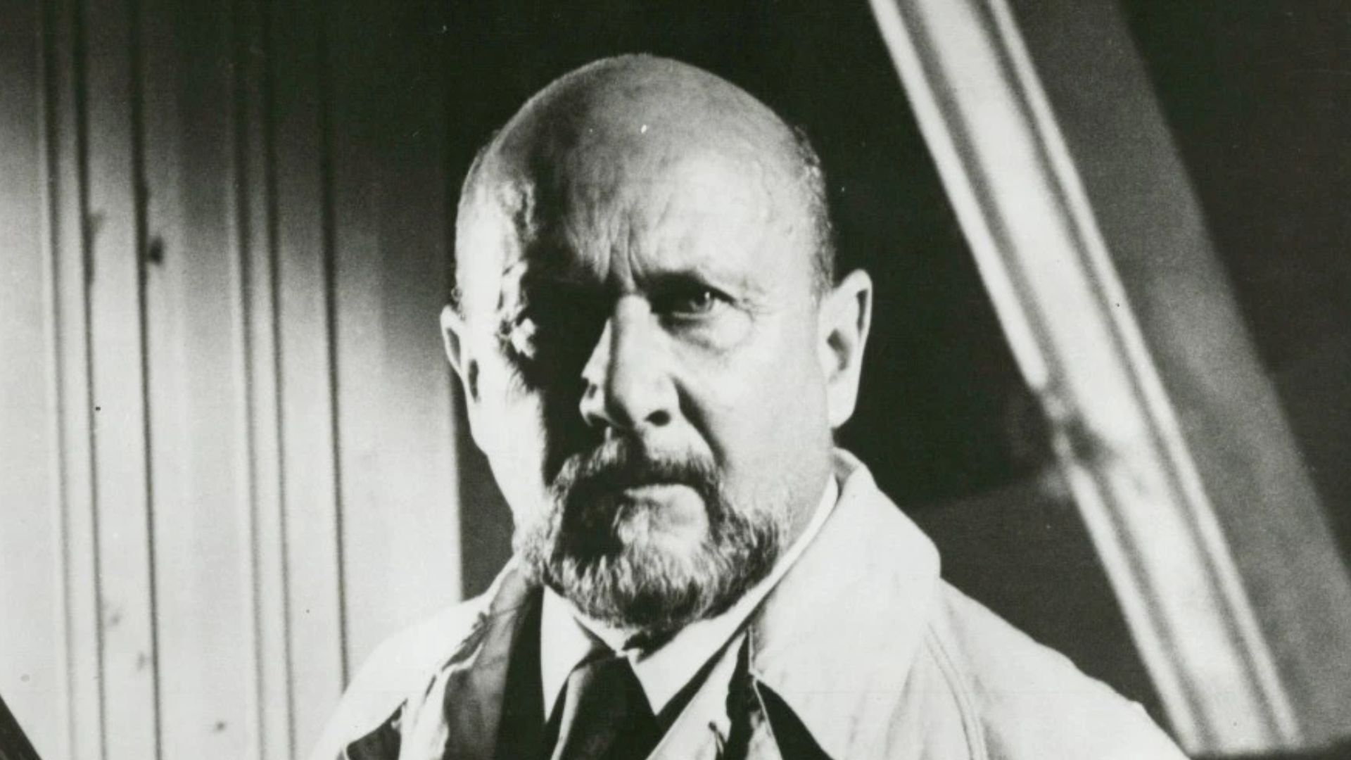 Donald Pleasence as Dr. Samuel Loomis in Halloween, investigating the childhood house of Michael Myers. Publicity still.