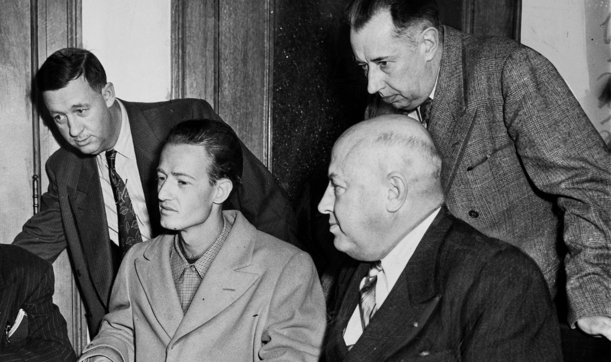 View of police officials, with Leslie Dillon (seated center), during the Elizabeth Short (known posthumously as the 'Black Dahlia ') murder investigation, Los Angeles, California, mid January, 1949. 