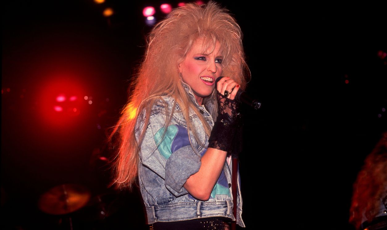 American Rock singer Janet Gardner, of the group Vixen, plays bass as she performs onstage at the Poplar Creek Music Theater, Hoffman Estates, Illinois, July 15, 1989.