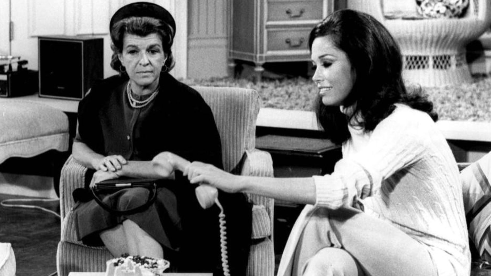 Photo of Nancy Walker as Ida Morgenstern and Mary Tyler Moore as Mary Richards from The Mary Tyler Moore Show.  In this episode, Ida, the mother of Rhoda, arrives in Minneapolis unannounced.  She has nowhere to stay when her daughter refuses to see her, s
