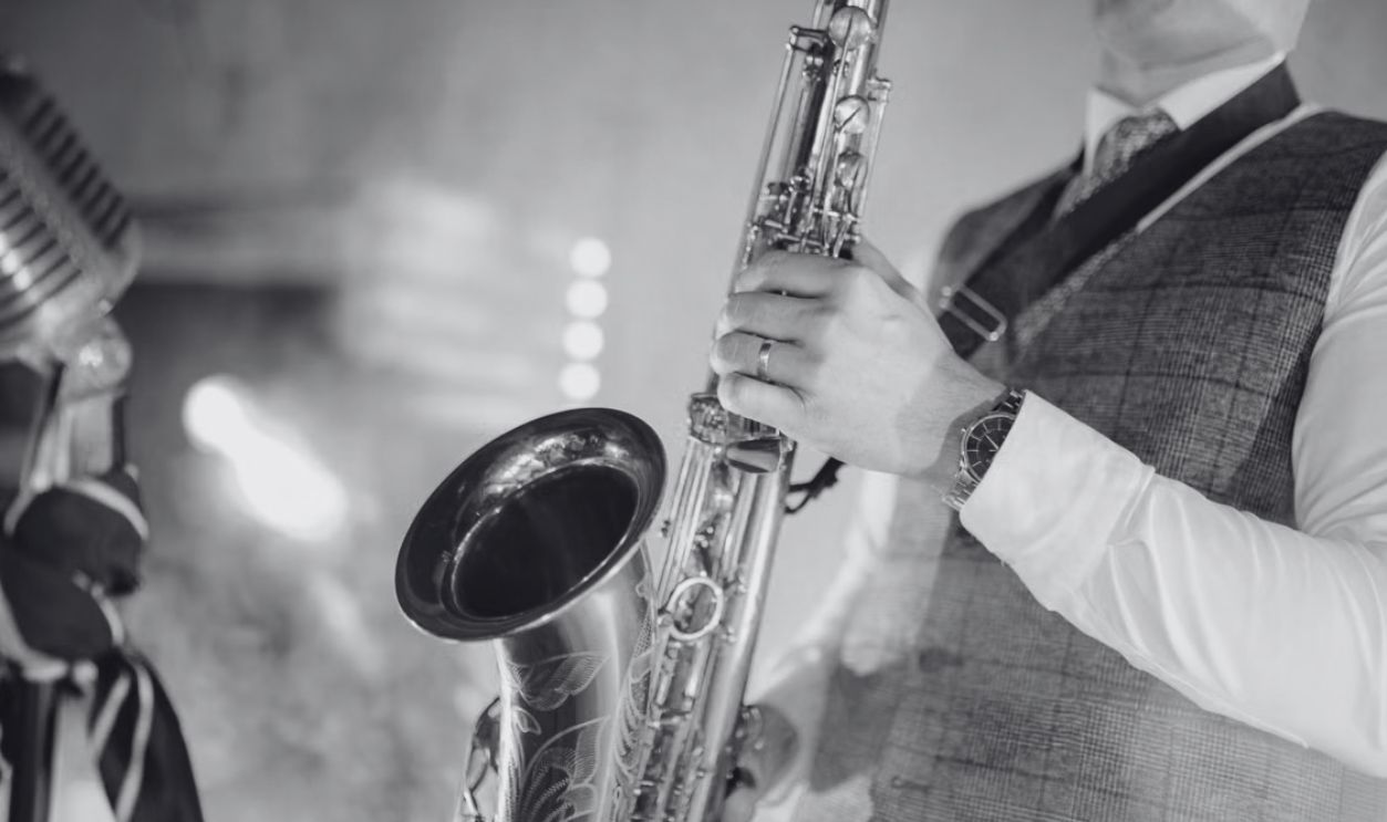 A musician passionately playing the saxophone, showcasing talent under colorful stage lights