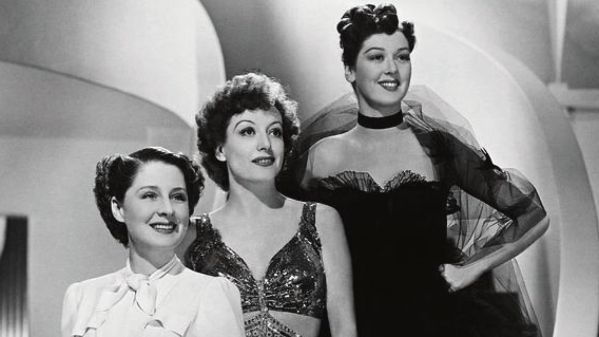 Norma Shearer, Rosalind Russell, and Joan Crawford in the American drama film The Women (1939). Costuem design by Adrian.