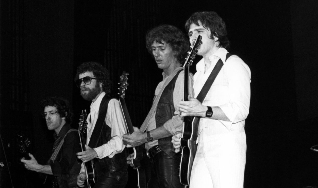 BLUE OYSTER CULT; performing live on stage, Eric Bloom (2nd L), Buck Dharma (C)